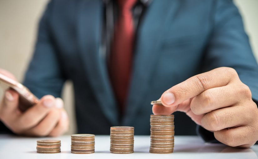 businessman hand stacking coins